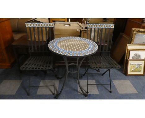 A Garden Patio Set in Metal and Mosaic Comprising Two Folding Chairs and a Circular Table. 