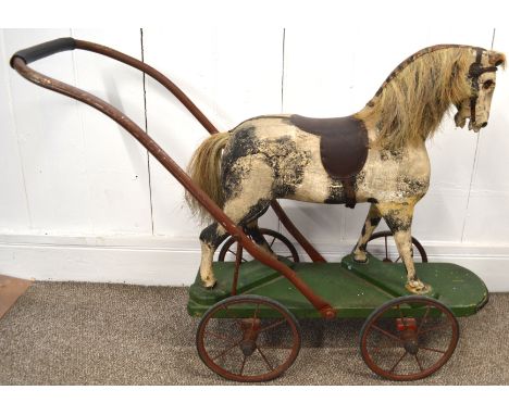 Vintage horse on wheels, piebald decoration. The total length is 90cm, the green base has a length of 67cm &  the height is 7