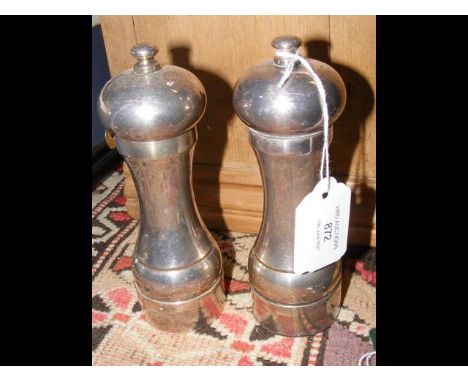 A pair of silver capstain style salt and pepper pots - 16cms highCONDITION REPORTfew signs of wear