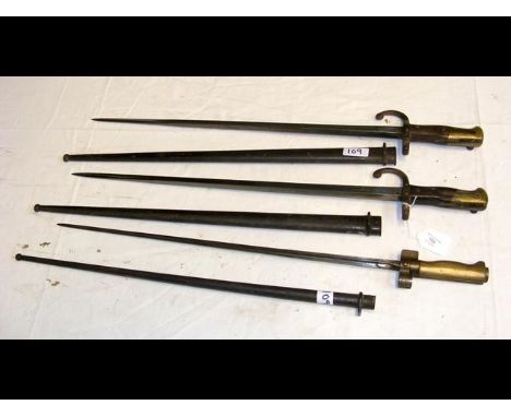 A sword bayonet with tapering blade and metal scabbard - 65cm long, together with two others 