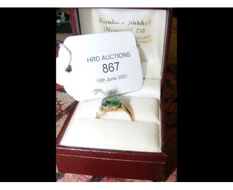 A ladies green baguette cut gemstone ring in 18ct setting