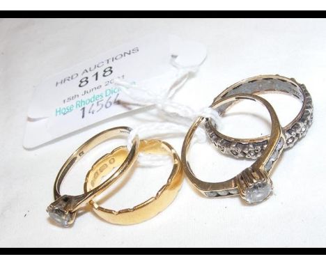A 22ct gold ring together with three others