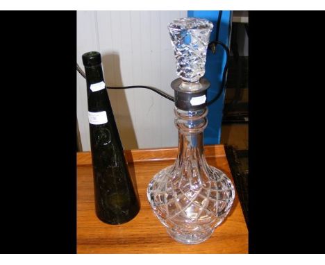 A silver mounted cut glass decanter with stopper, together with an old green glass conical bottle 