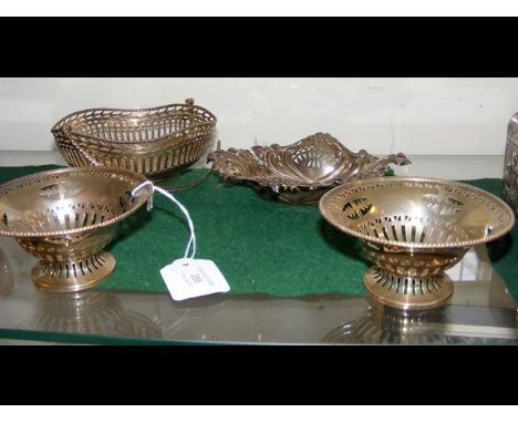 A pierced silver basket together with a pair of bon bon dishes and one other