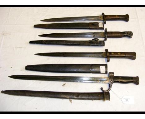 A sword bayonet with metal scabbard - 53cm long, together with three others 