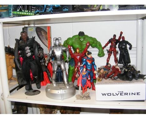 A collection of Marvel and DC comic book figures and action toys, including Superman, Deadpool, Iron Man, Wonder Woman and Th