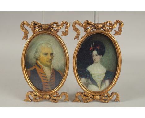 A LARGE PAIR OF GEORGIAN STYLE OVAL PORTRAIT MINIATURES in gilt frames. 7ins x 4.5ins.