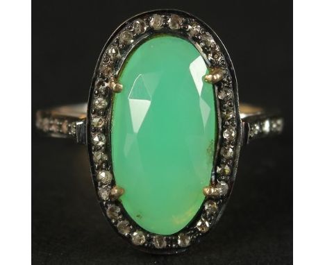 A DRESS RING set with a central chrysoprase and rose-cut diamonds in silver gilt. Oval cabochon chrysoprase 2.88ct. Diamonds 