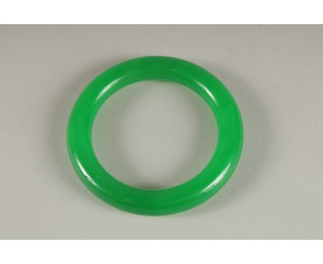 AN APPLE GREEN JADE BANGLE.