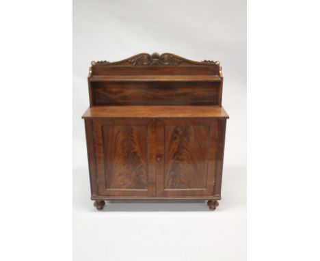 A LATE REGENCY MAHOGANY CHIFFONIER with shaped back, single shelf over a pair of double doors, on turned legs. 4ft high x 3ft
