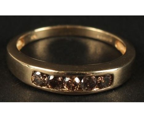 A 9CT YELLOW GOLD 5-STONE NATURAL CINNAMON DIAMOND RING, channel set. RBC diamonds 0.45ct approx.