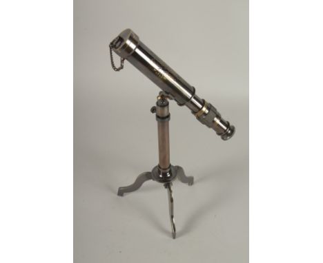 A SMALL TELESCOPE ON A STAND.