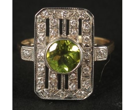 A 9CT WHITE AND YELLOW GOLD VINTAGE-STYLE PERIDOT AND DIAMOND RING. Peridot 0.85ct. Diamonds 0.26ct.