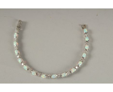 A SILVER AND OPAL LINE BRACELET.