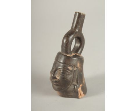 A SMALL TERRACOTTA SOUTH AMERICAN FLASK in the form of a man's head. 9cms high.