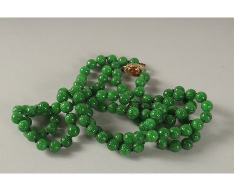 A SUPERB JADE BEAD NECKLACE with diamond, gold and citrine clasp.