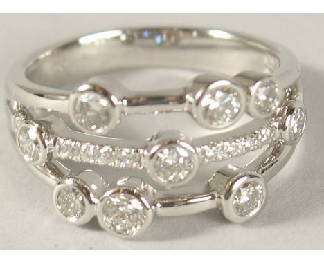 A PLATINUM AND DIAMOND "RAIN DROP" HALF HOOP RING, 1ct.