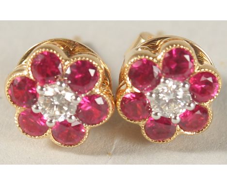 A PAIR OF 18CT YELLOW GOLD, RUBY AND DIAMOND FLOWER HEAD CLUSTER EAR STUDS.