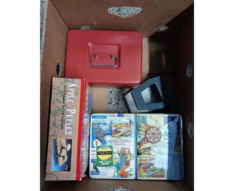 CARTON WITH A RED MONEY BOX, APPLE PEELER, DECORATIVE TIN & A PAPER PUNCH