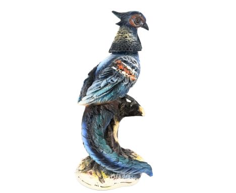 "An impressive figurine made of colorful porcelain, depicting a bird perched on a branch.Made by Capodimonte, Italy." Height: