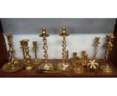 SHELF OF BRASS WARE, MAINLY CANDLESTICKS