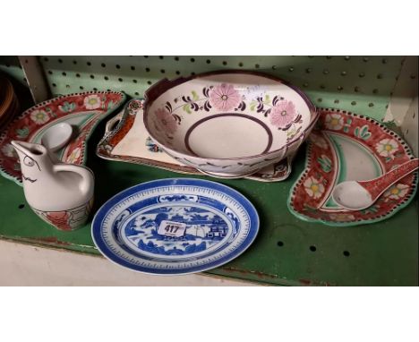 SHELF OF POTTERY ITEMS