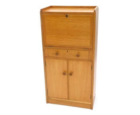 A light oak escritoire or bureau, in Heals style, with a raised gallery, enclosing a fitted interior with brown leatherette i