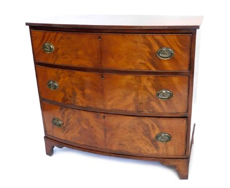 A 19thC bow fronted chest of drawers, the top with a reeded edge, above three drawers with oval brass drop handles, and brack