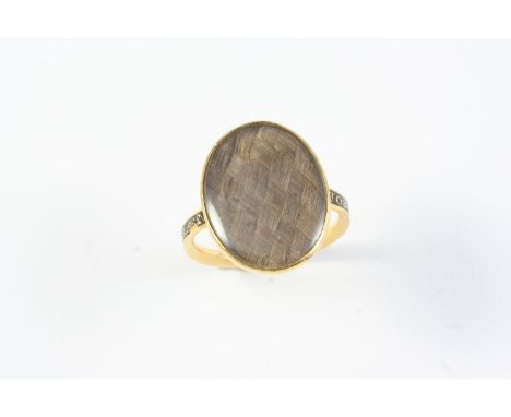 A GEORGE III GOLD AND BLACK ENAMEL MOURNING RING the centre section containing hair, with inscription for Joseph Davenport da