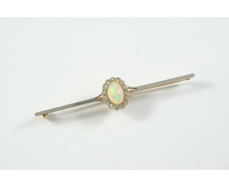 AN OPAL AND DIAMOND CLUSTER BROOCH the oval-shaped solid white opal is set within a surround of single-cut diamonds in 15ct g