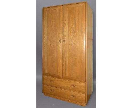 ERCOL WARDROBE a large light elm wardrobe, the top section with two doors to reveal a shelf and hanging rail. The bottom sect