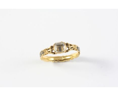 A GEORGE II ROCK CRYSTAL SET RING the cushion-shaped rock crystal is set in gold closed back setting, with foliate decoration