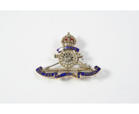 A DIAMOND AND ENAMEL REGIMENTAL BROOCH FOR THE ROYAL ARTILLERY mounted with rose-cut diamonds and with blue and red enamel de