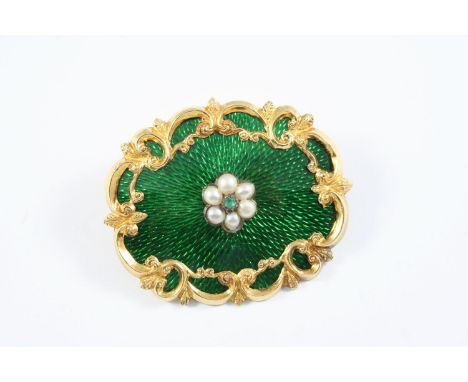 A VICTORIAN ENAMEL AND GOLD BROOCH the green guilloche enamel with gold foliate scrolling decoration, centred with a cluster 