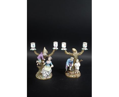 PAIR OF MEISSEN CANDLEABRA a pair of late 19thc figural twin branch candelabra, one modelled with figures gathering eggs and 