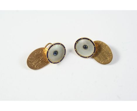 A PAIR OF MOTHER OF PEARL AND 15CT GOLD CUFFLINKS each formed with a circular mother of pearl link centred with a sapphire ca