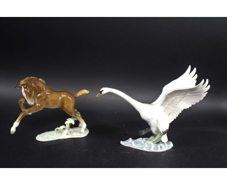 HUTSCHENREUTHER PORCELAIN SWAN a porcelain model of a Swan in flight over water, 22cms high, and a porcelain model of a jumpi