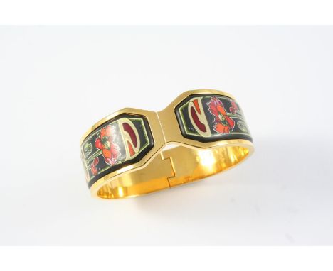 AN ENAMEL AND GOLD PLATED HALF HINGED BANGLE BY FREY WILLE decorated to one side with foliate polychrome enamel, internal mea