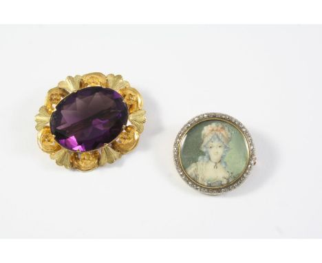 AN AMETHYST AND GOLD BROOCH the oval-shaped amethyst is set within an ornate foliate mount, 4cm wide, together with a gold po