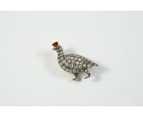A VICTORIAN DIAMOND GROUSE BROOCH set overall with circular-cut diamonds in silver and gold, with red enamel crest, 3cm wide