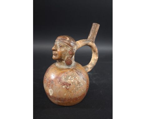 MOCHE STIRRUP VESSEL - PERU circa 1st to 5th Century AD, a pottery portrait stirrup vessel with curved handle, and with vario