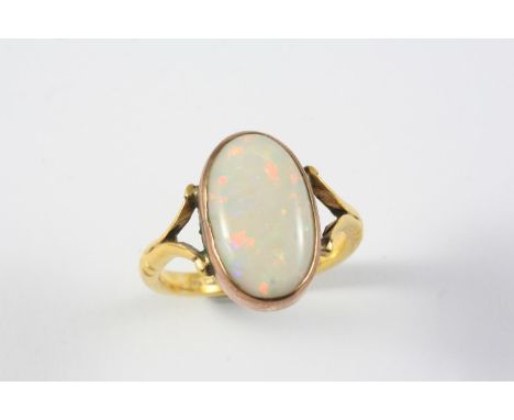 AN OPAL AND GOLD RING the oval-shaped solid white opal is set in 22ct gold. Size V