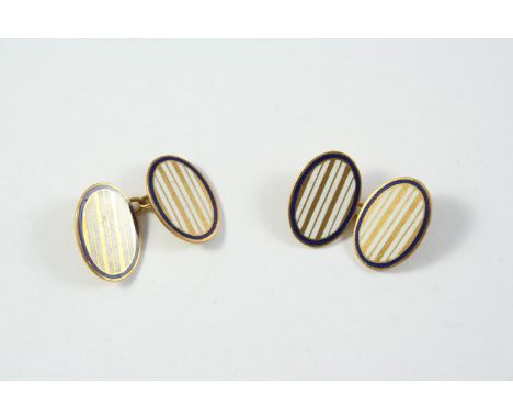 A PAIR OF 18CT GOLD AND ENAMEL CUFFLINKS of oval form, each link with white enamel and gold striped decoration with a blue en