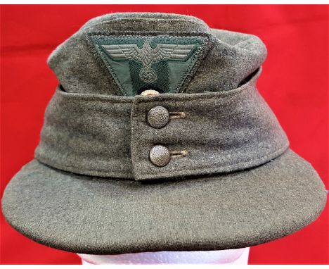 WW2 M43 German Army uniform field cap. Field grey wool body peak (showing light folding to centre) and fold down flaps, retai