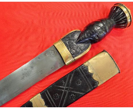 Early to mid-18th century Scottish clan dagger dirk with scabbard. Features tooled blackened wood with brass mounts, hammer s