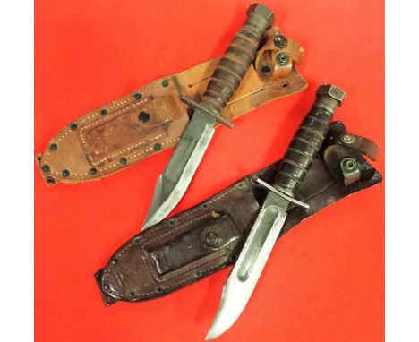 Both knives feature leather stacked handles with heavy hexagonal hammer pommel nuts, one maker named and dated 11-1968, both 