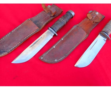 WW2 U.S. Cattaraugus 225Q commando fighting knives with scabbards (2). Both knives feature leather stacked handles with heavy