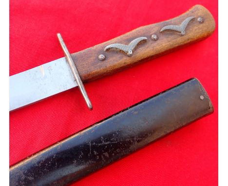 WW2 German Luftwaffe gull winged decorated hilt boot fighting knife with scabbard. Features wooden grips enhanced with 4 meta