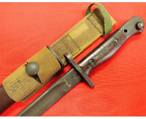 1954 Korean War Australian Owen S.M.G. bayonet with scabbard by Orange Arsenal, Lithgow. Features 52 dated wooden grips, with