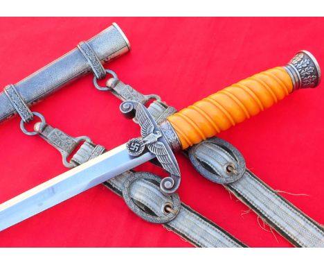 WW2 German Army officer’s dagger &amp; scabbard by Carl Eickhorn with hangers. Orange coloured celluloid grip is in very good